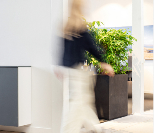A woman walking on the beige floor in the 7N office in Copenhagen